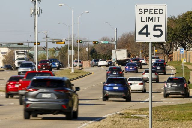 Cars drive along Preston Road past a new speed limit sign, Wednesday, Jan. 3, 2024, in...